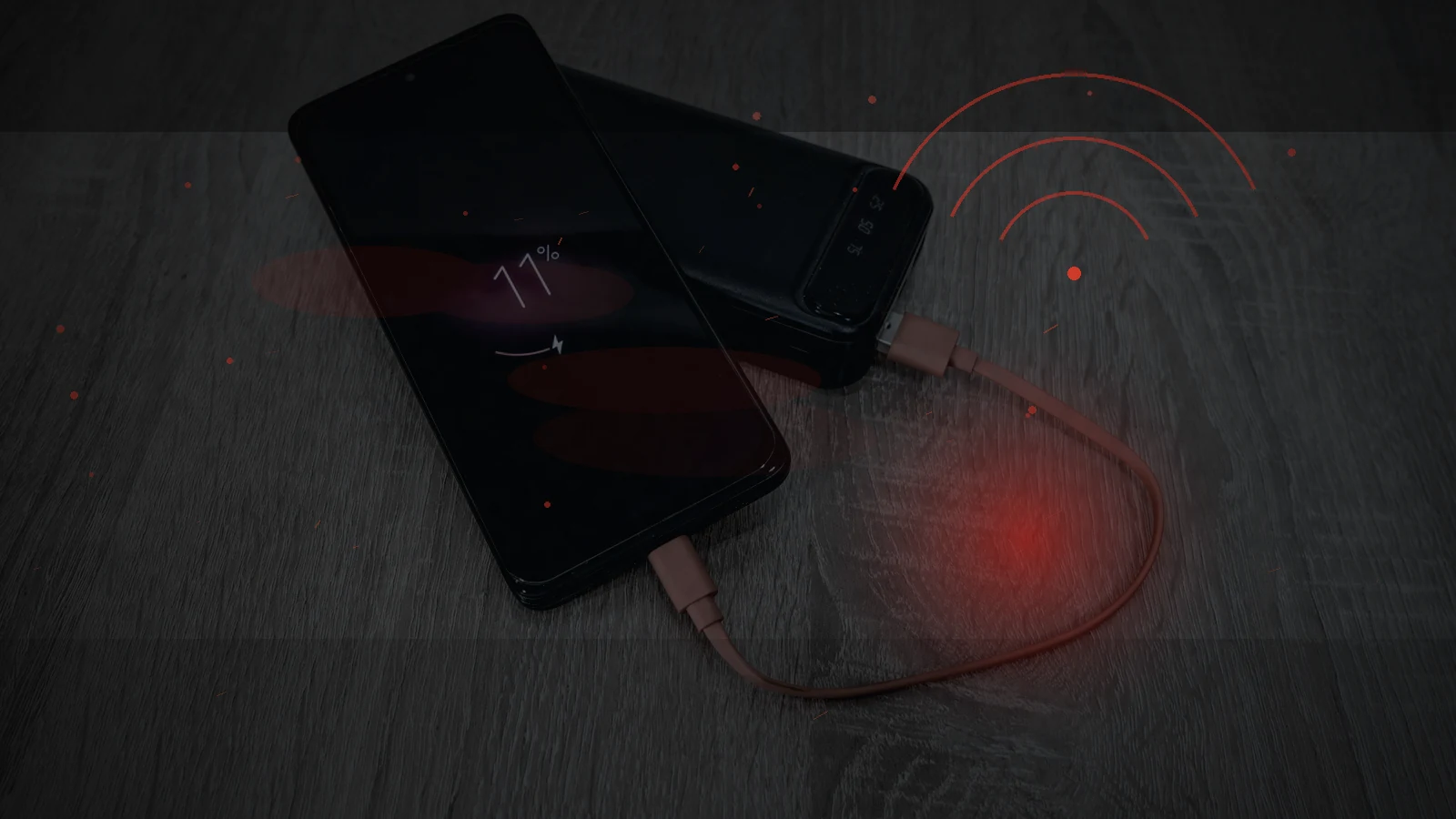 A smartphone connected to a portable power bank as its battery runs low during an outage