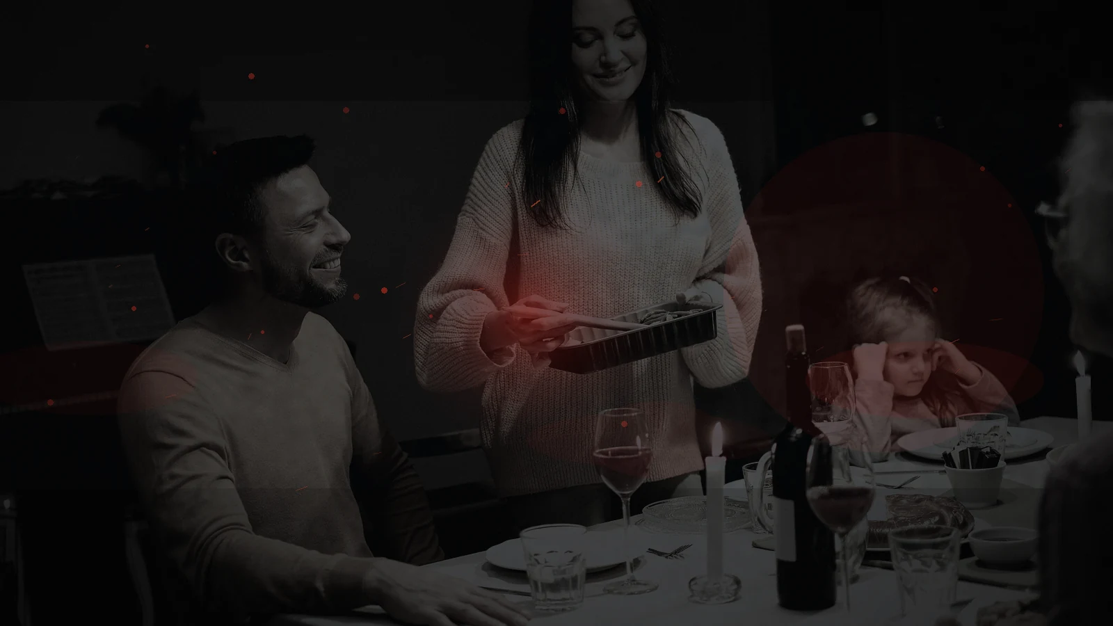 A household sharing a candle-lit meal as normal electrical lighting remains unavailable