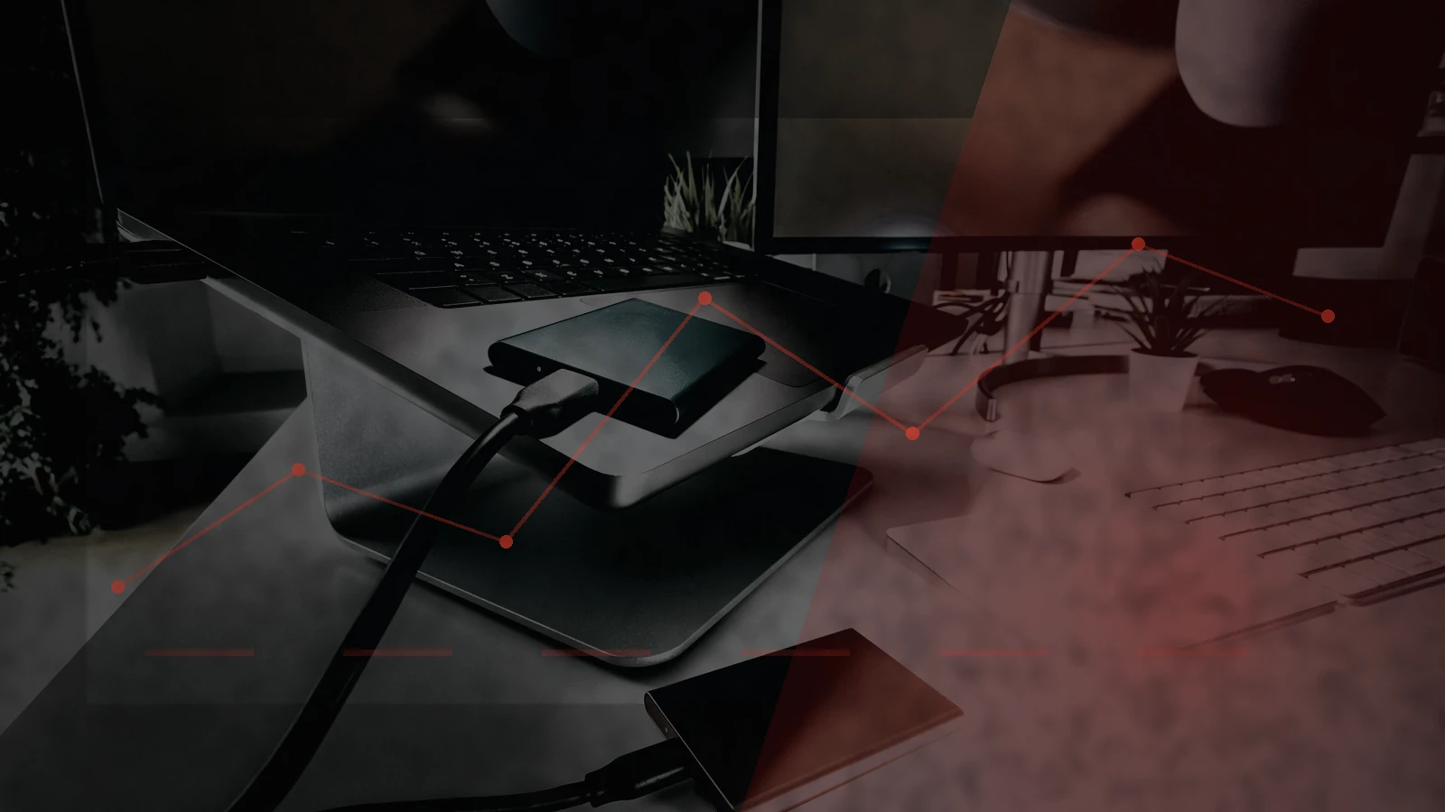 External backup drives connected to a laptop, graded into the site’s dark emergency visual system