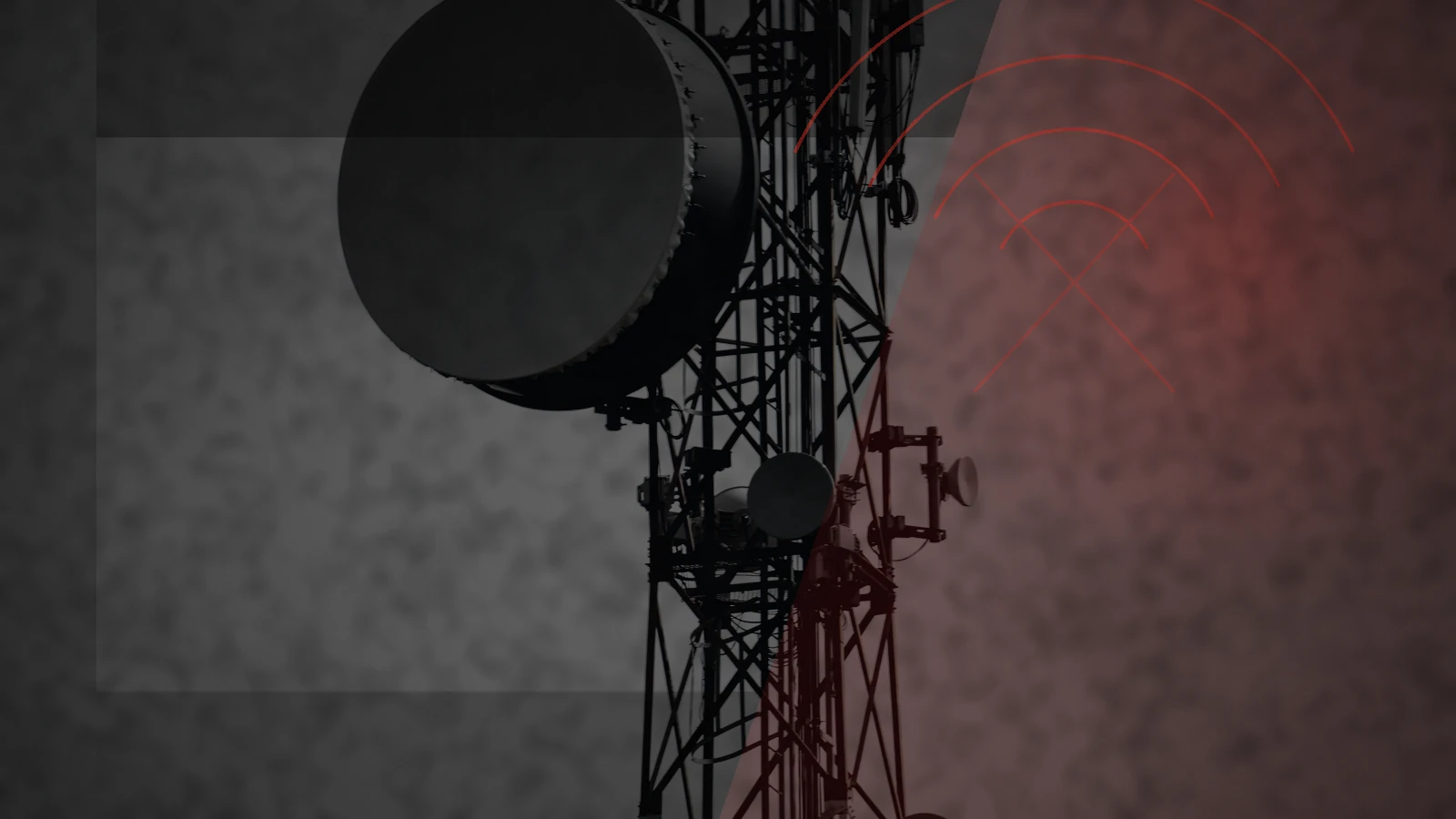 Telecommunications tower under a storm-dark sky, illustrating mobile network failure during a wider emergency